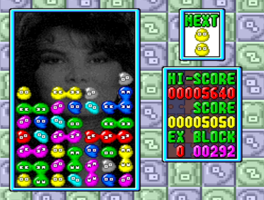 news gameplay. its puyo with a woman looking over the pile of blobs